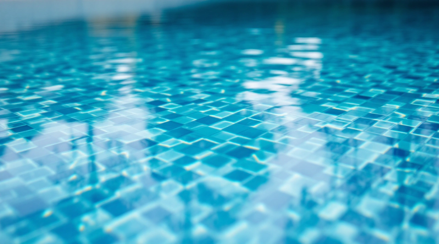 Quiet pool water and surrounding deck in natural light